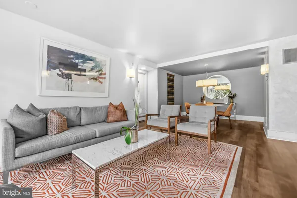 a living room with furniture and wooden floor