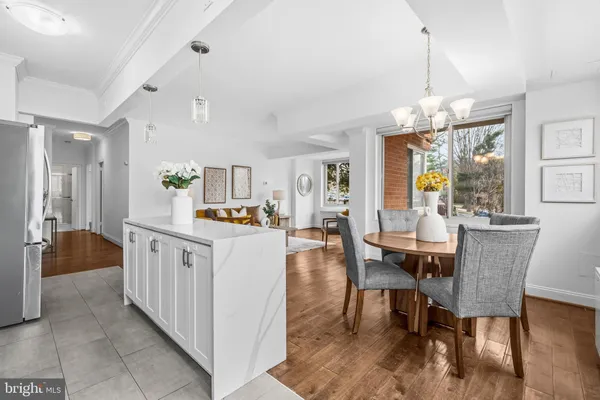 a kitchen with stainless steel appliances granite countertop dining table chairs and granite counter tops