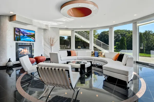 a living room with furniture and a floor to ceiling window