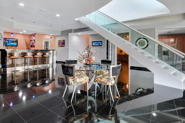 a dining room with furniture and a floor to ceiling window