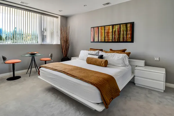 a bedroom with a bed and a window