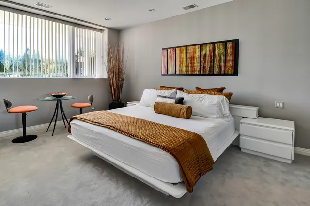 a bedroom with a bed and a window