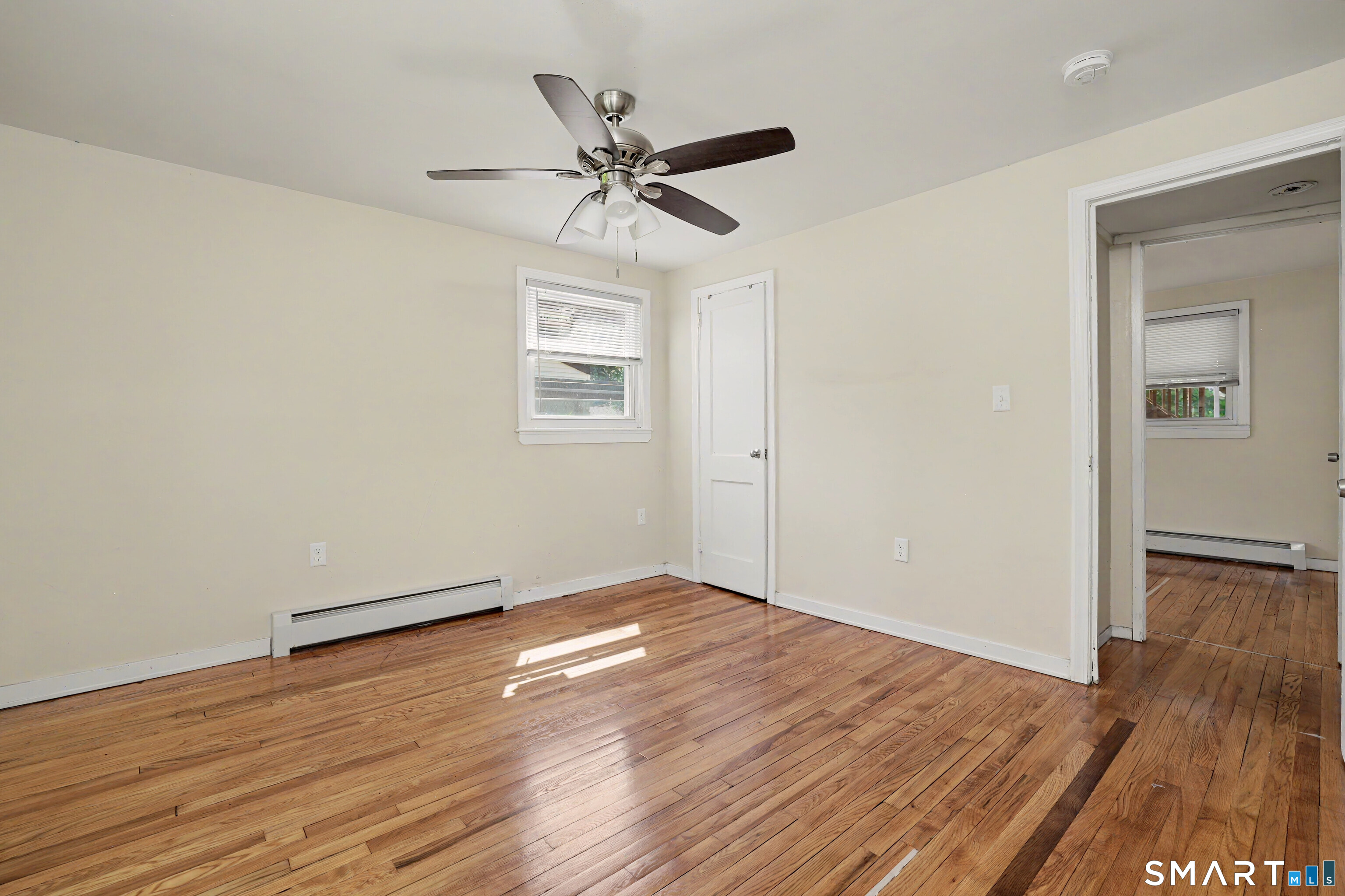 97 Boothbay Street Bloomfield, CT 06002 - Photo 20 of 33 an empty room with wooden floor fan and windows