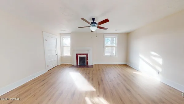 wooden floor in an empty room with a window