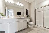406 Bold Ruler Court, Unit 204 Havre de Grace, MD 21078 - Photo 22 of 34 a bathroom with a double vanity sink mirror and toilet