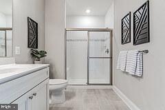 406 Bold Ruler Court, Unit 204 Havre de Grace, MD 21078 - Photo 23 of 34 a bathroom with a sink a mirror and a shower