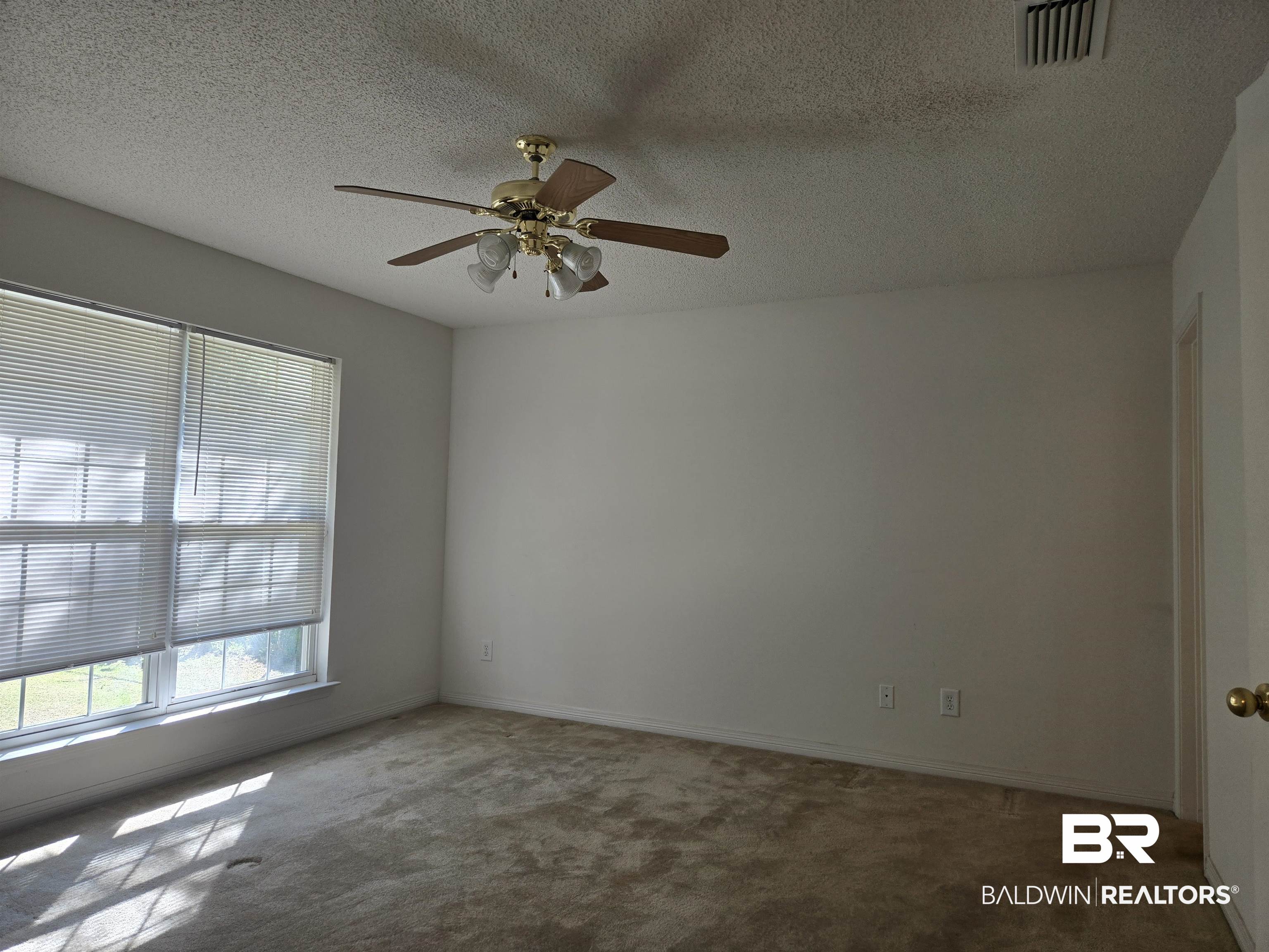 2554 Riverside Drive Mobile, AL 36605 - Photo 17 of 43 Carpeted empty room with a textured ceiling and a ceiling fan