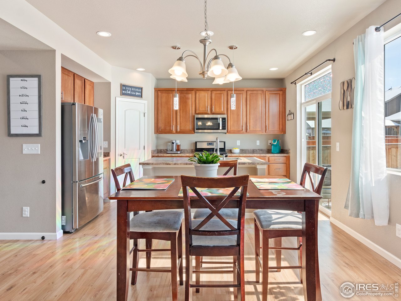 465 Country Road Berthoud, CO 80513 - Photo 3 of 34 Dining Room to the Kitchen
