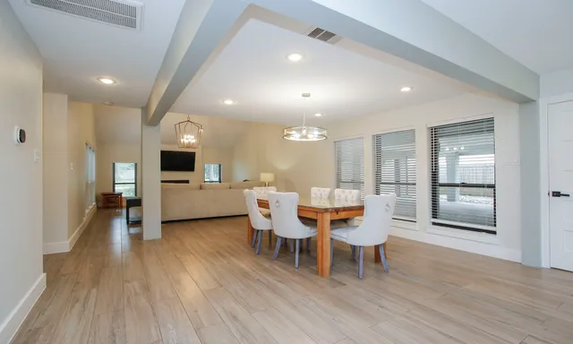 a dining room with furniture and wooden floor