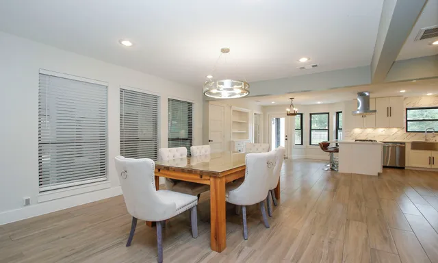 a dining room with furniture and wooden floor