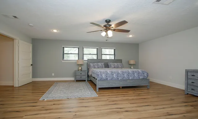 a living room with a bed furniture and a window