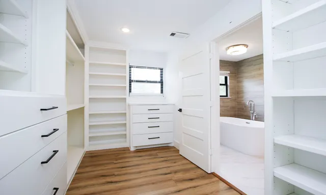 a view of walk in closet and bedroom