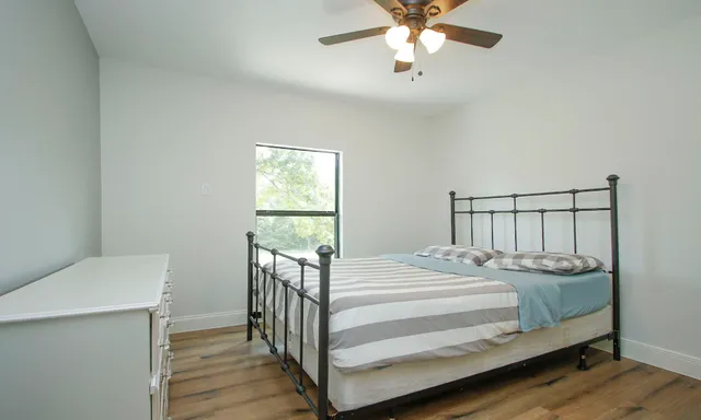 a bedroom with a bed and a chandelier