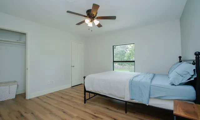 a bedroom with a bed and a window