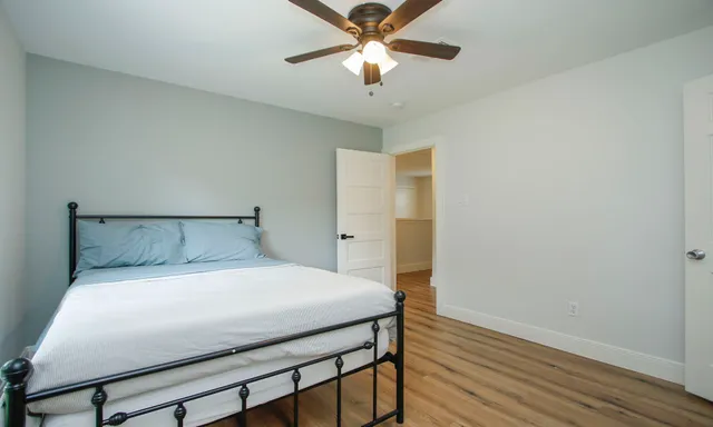 a bedroom with a bed and a chandelier