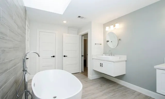 a bathroom with a double vanity sink and mirror