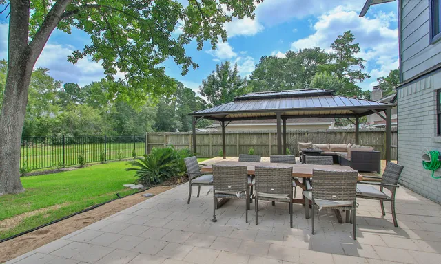 a view of backyard with outdoor seating and green space