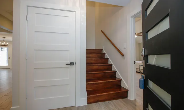 a view of staircase with white walls and a window