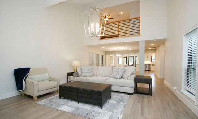 a living room with furniture a rug and a window