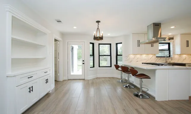 a view of kitchen with sink microwave and stove