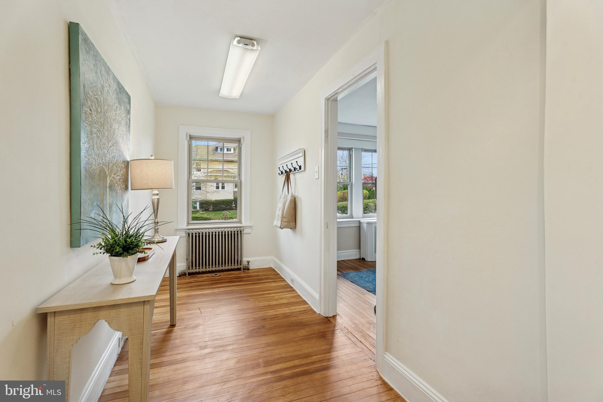 2501 West Darby Road Havertown, PA 19083 - Photo 11 of 30 a view of a hallway with wooden floor and a living room