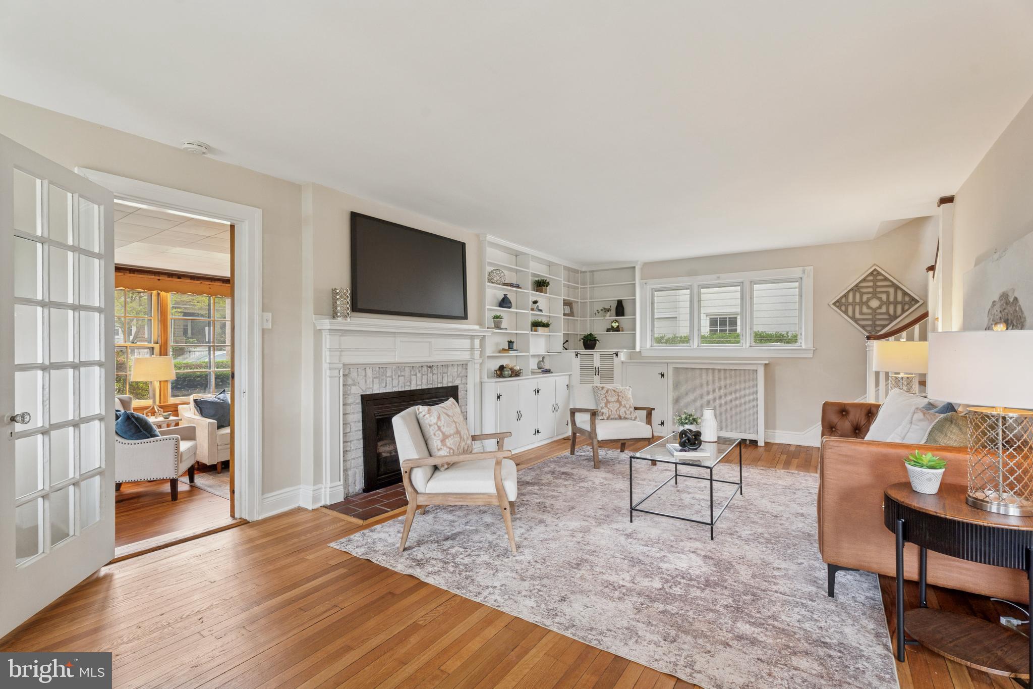 2501 West Darby Road Havertown, PA 19083 - Photo 2 of 30 a living room with furniture a fireplace and a flat screen tv