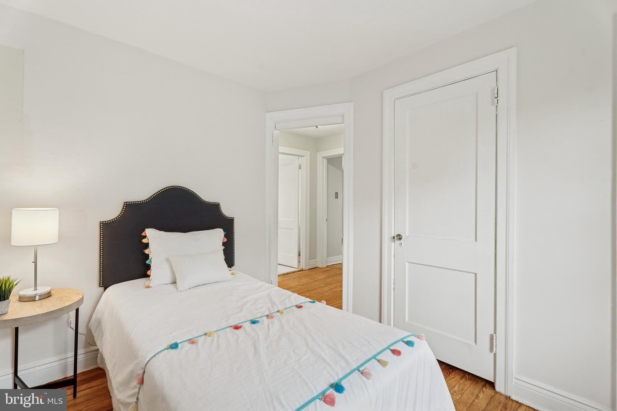 2501 West Darby Road Havertown, PA 19083 - Photo 22 of 30 a bedroom with a bed and a lamp on the table