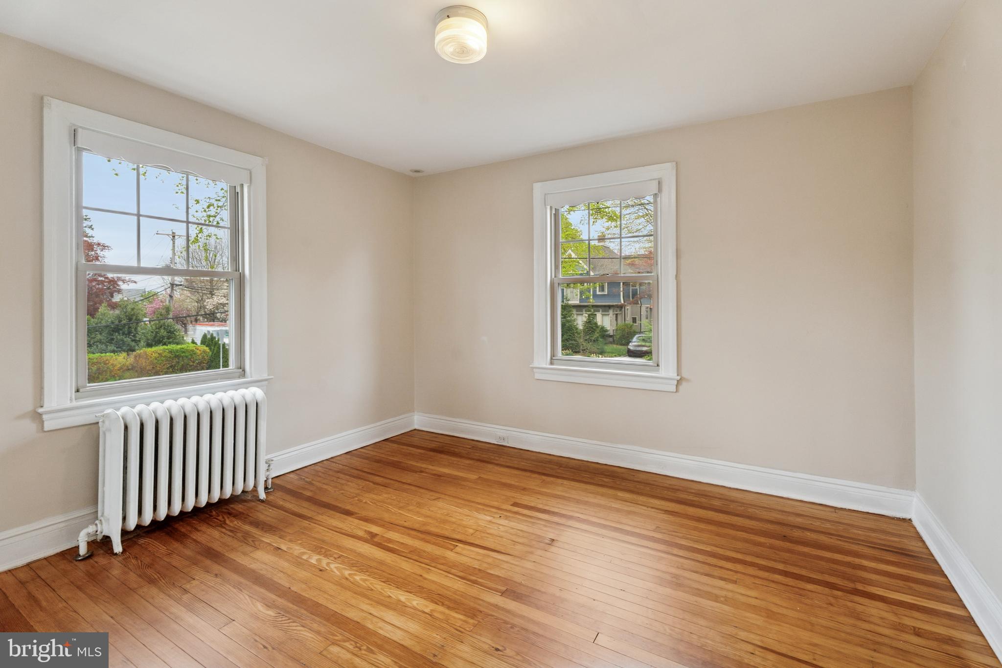 2501 West Darby Road Havertown, PA 19083 - Photo 23 of 30 a view of an empty room with wooden floor and a window