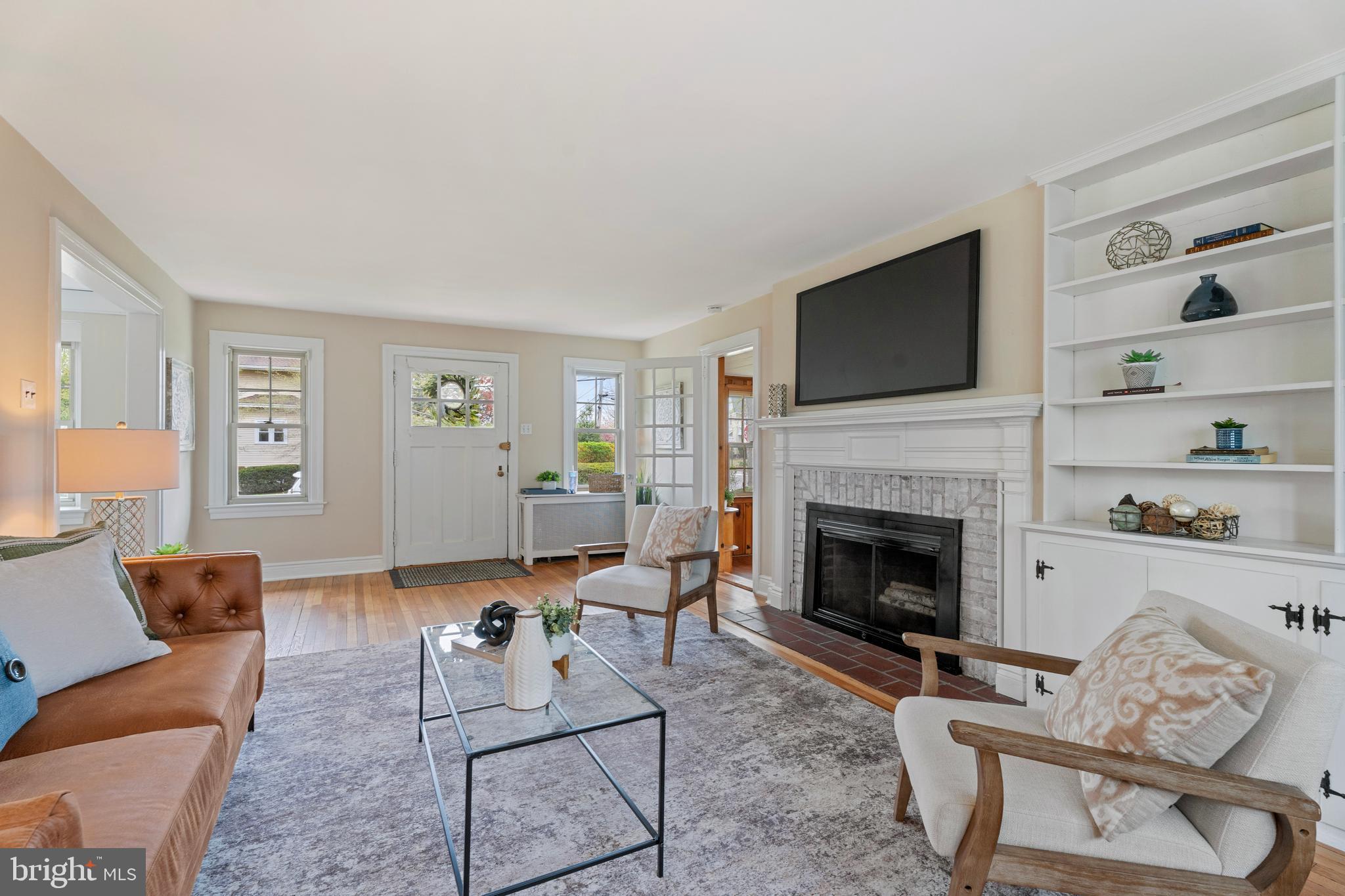 2501 West Darby Road Havertown, PA 19083 - Photo 3 of 30 a living room with furniture a flat screen tv and a fireplace
