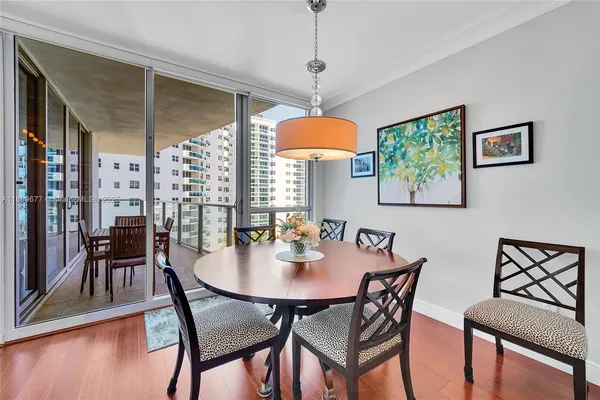 a view of a dining room with furniture and a chandelier