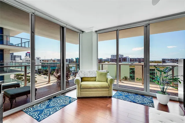 a bedroom with furniture and a large window