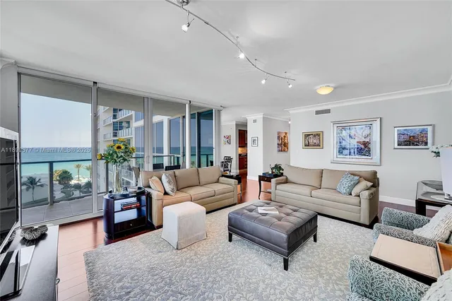 a living room with furniture a flat screen tv and a large window