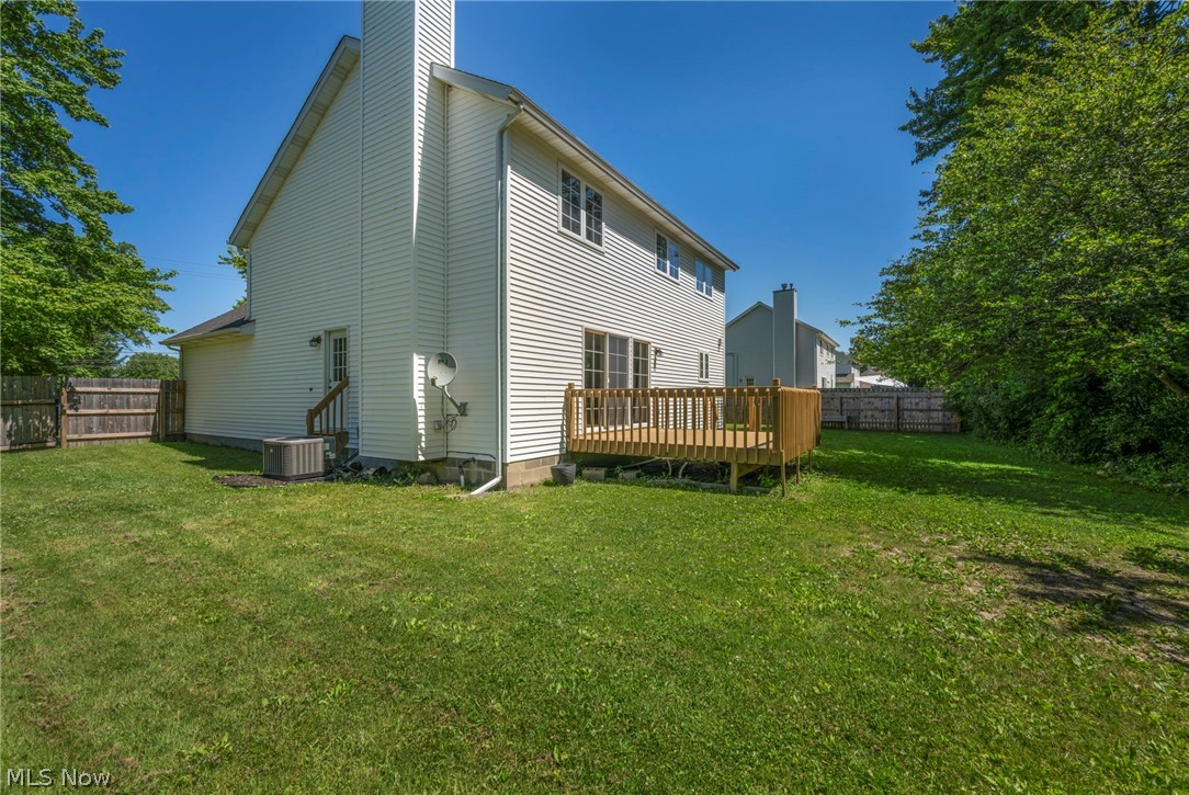 9842 Johnnycake Ridge Road Mentor, OH 44060 - Photo 35 of 40 Expansive green lawn surrounds the property, featuring a wood deck with railings