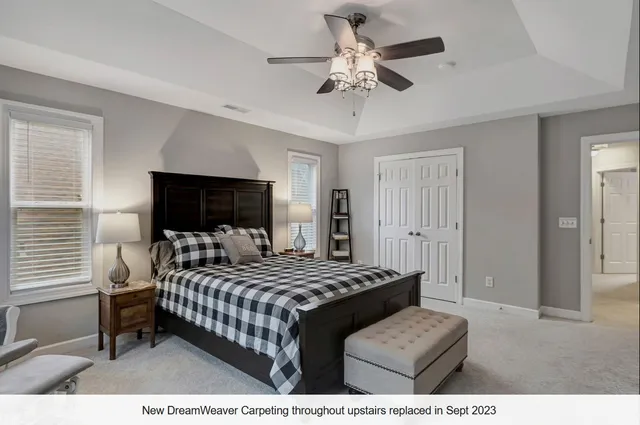 a workspace with furniture and a ceiling fan