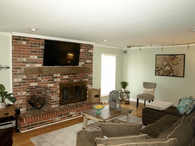 659 Aberdeen Road Inverness, IL 60067 - Photo 5 of 25 a living room with furniture a flat screen tv and a fireplace