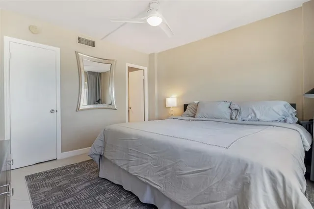 a bedroom with a bed and a mirror