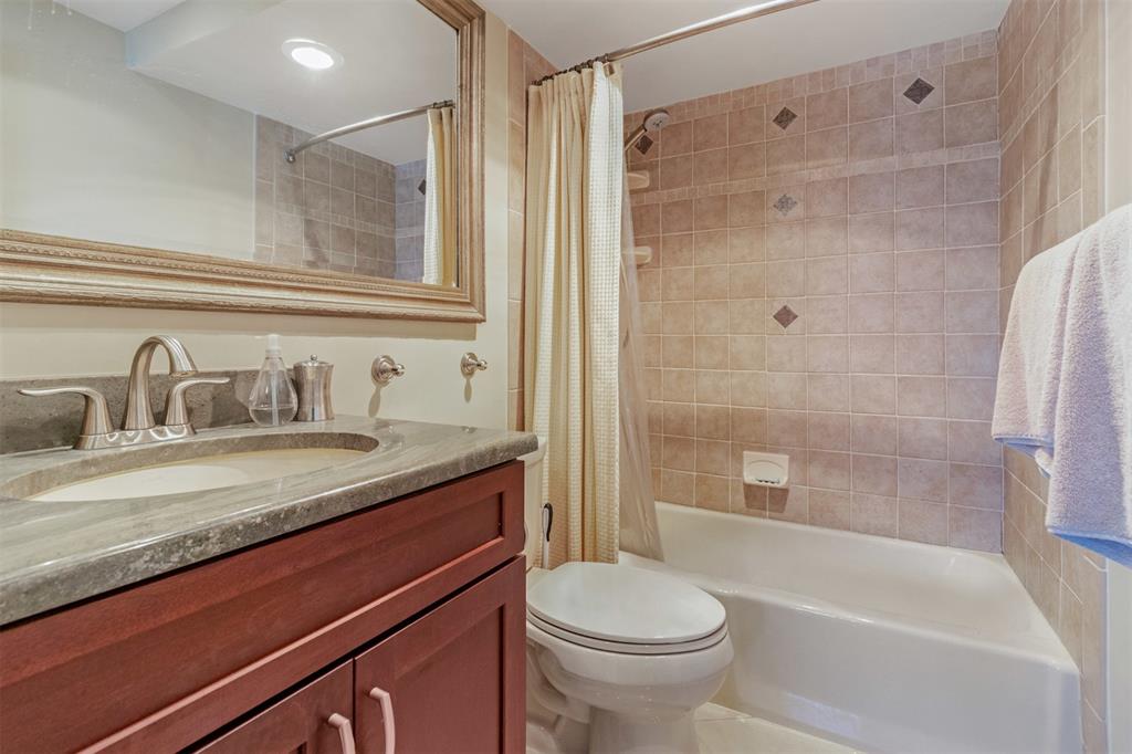 710 North Ocean Boulevard, Unit 806 Pompano Beach, FL 33062 - Photo 12 of 19 a bathroom with a granite countertop sink toilet and shower