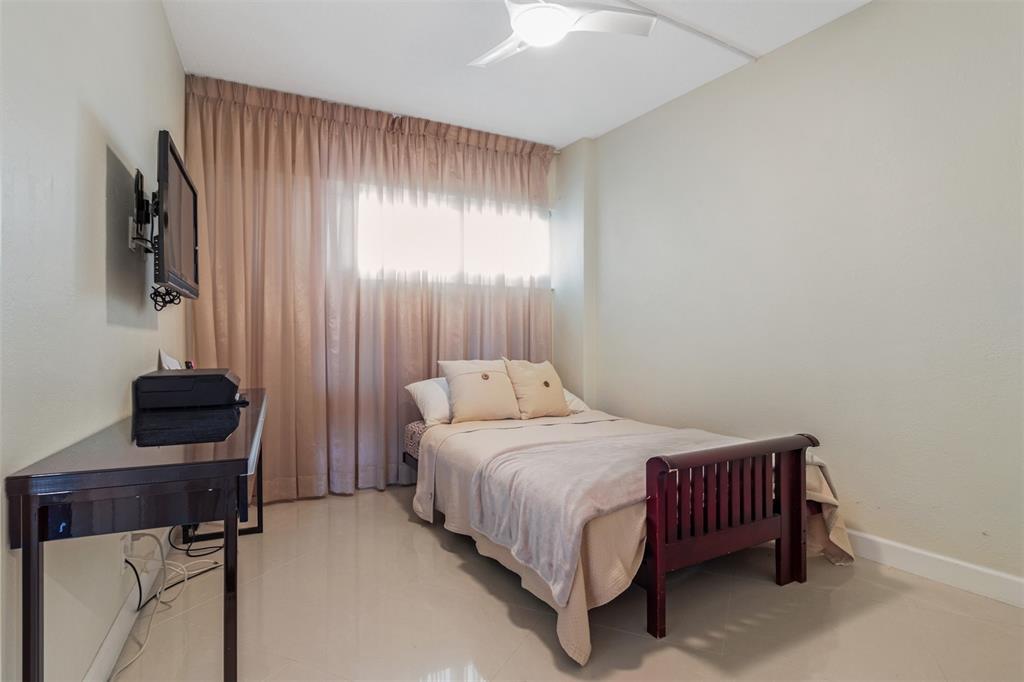 710 North Ocean Boulevard, Unit 806 Pompano Beach, FL 33062 - Photo 13 of 19 a bedroom with a bed and a television