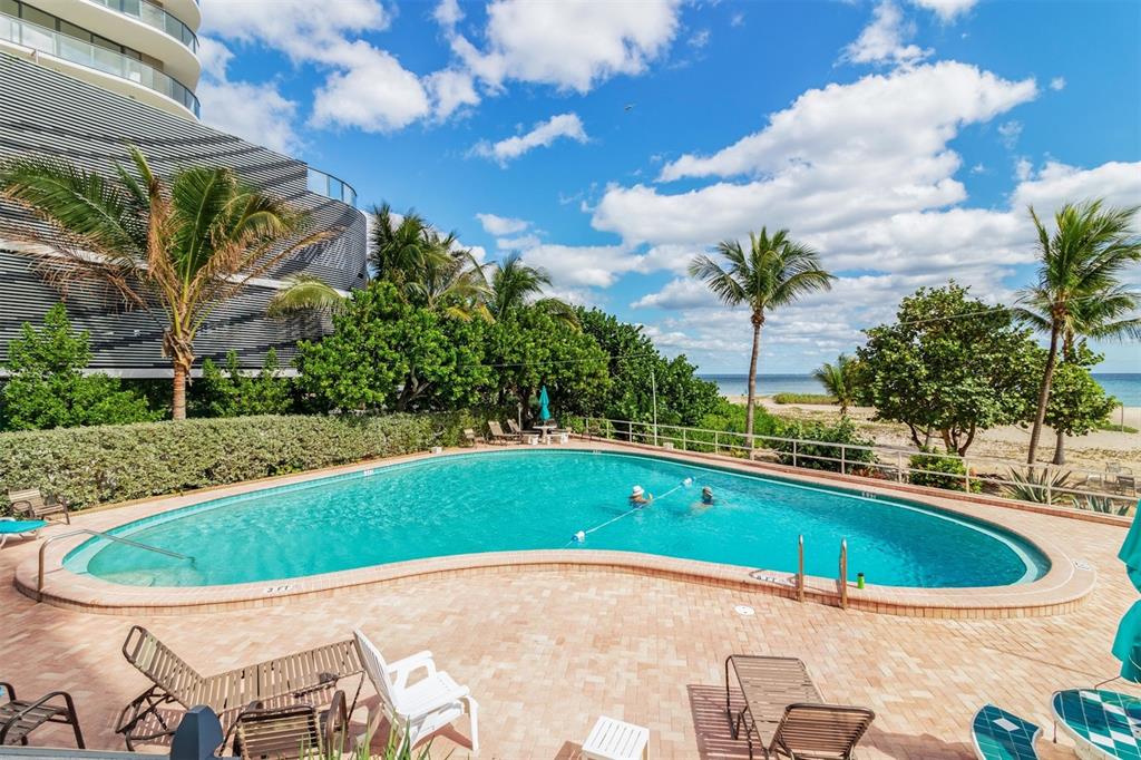 710 North Ocean Boulevard, Unit 806 Pompano Beach, FL 33062 - Photo 17 of 19 a view of a swimming pool with a yard