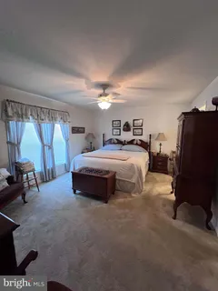 a bedroom with a bed and a chair