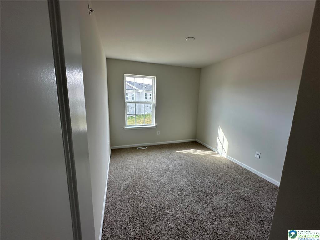 1145 Martin Road Breinigsville, PA 18031 - Photo 31 of 38 An inviting room, versatile and ready for your personal touch, boasts soft carpet and natural light from a well-placed window.