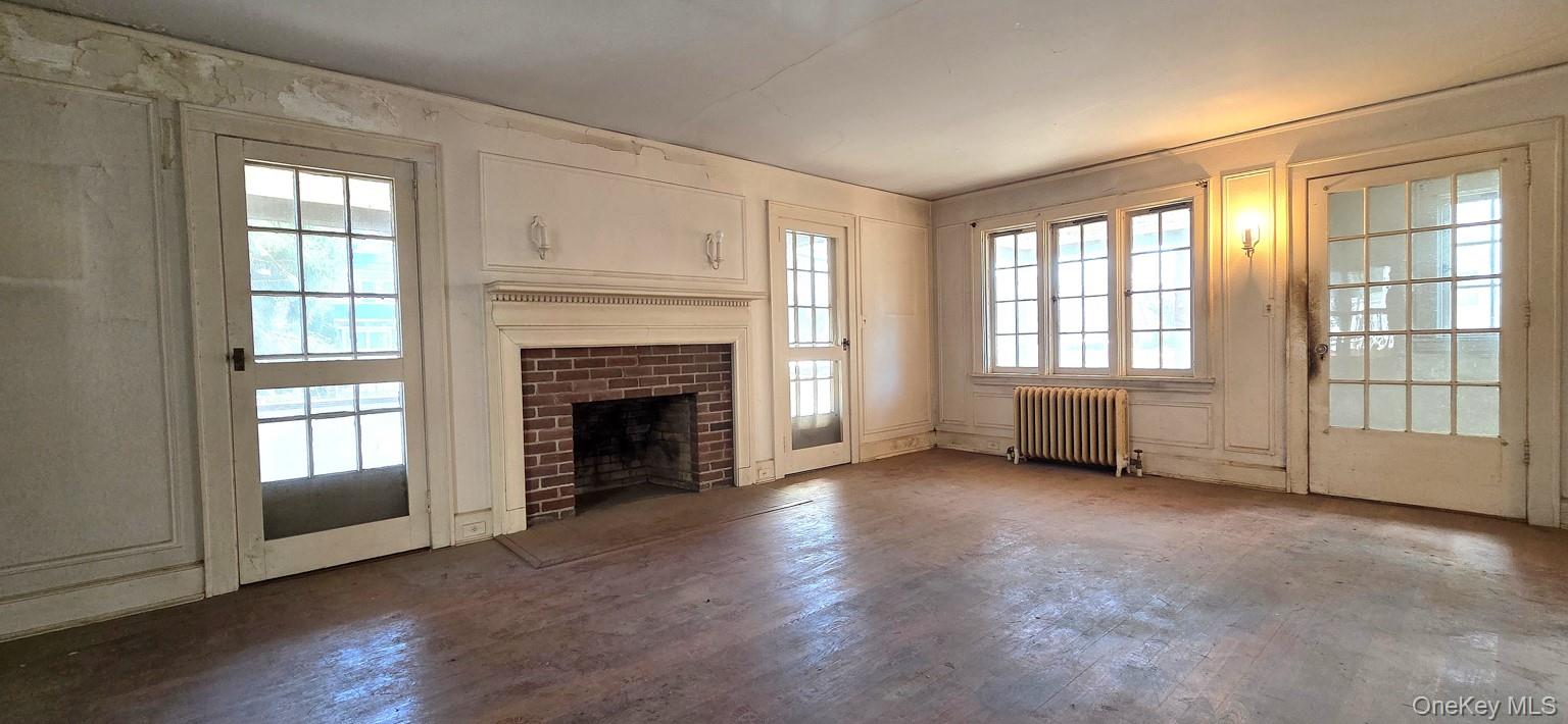 540 Webster Avenue New Rochelle, NY 10801 - Photo 3 of 18 Living room has wood-burning fireplace and doors to front porch