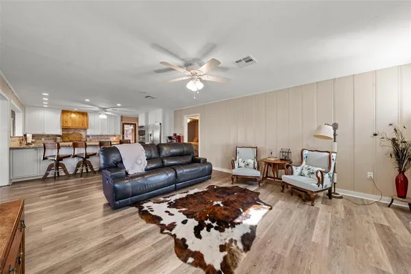 a living room with furniture and wooden floor
