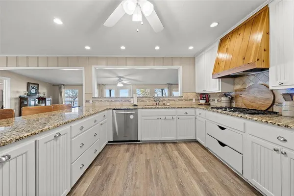 a large white kitchen with a large window