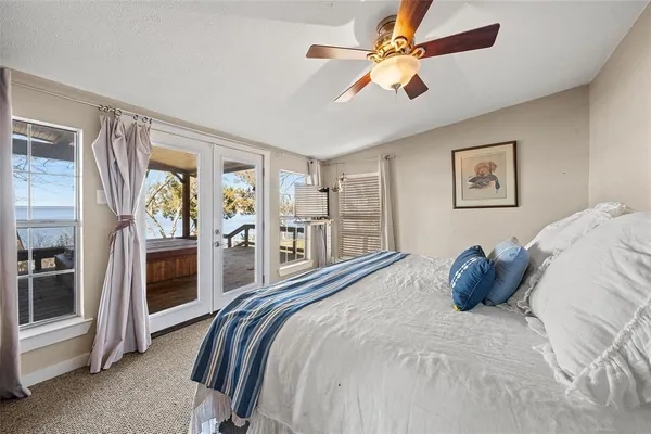 a bedroom with a large bed and a chandelier