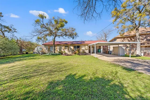 a front view of a house with a big yard