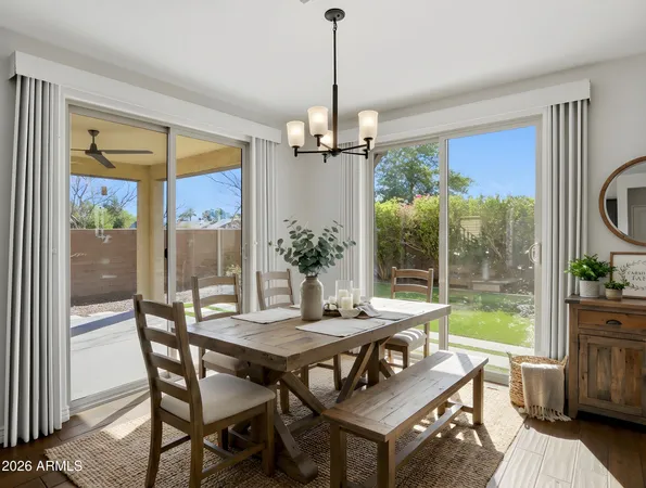a view of a room with wooden floor and a floor to ceiling window