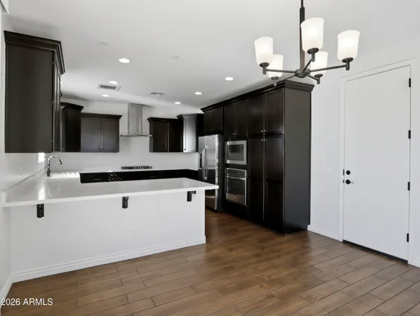 a kitchen with stainless steel appliances granite countertop a sink and a stove