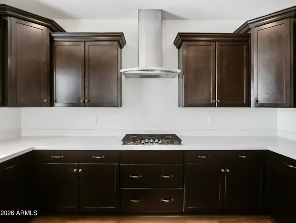 a metallic refrigerator freezer sitting in a kitchen