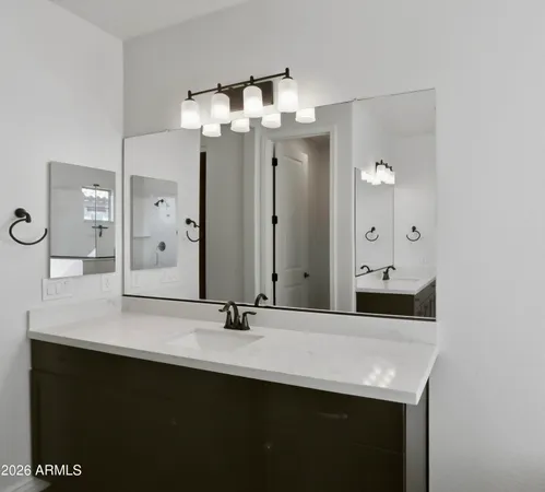 a bathroom with a sink a mirror and shower
